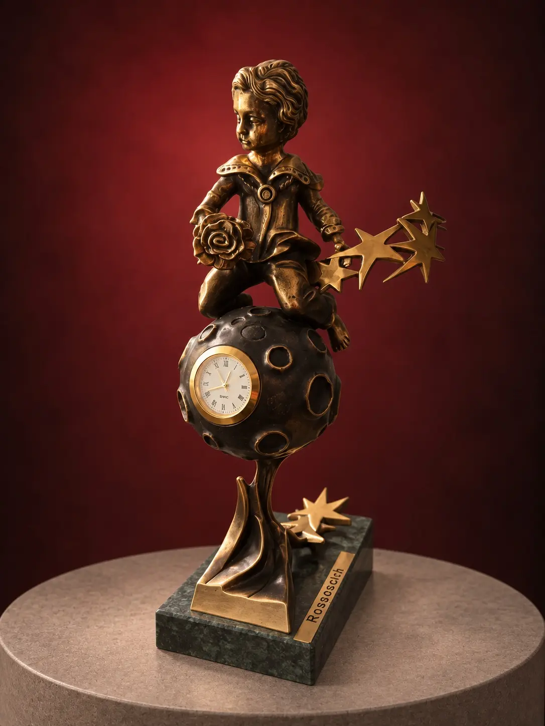 Bronze clown statuette with a clock and golden stars