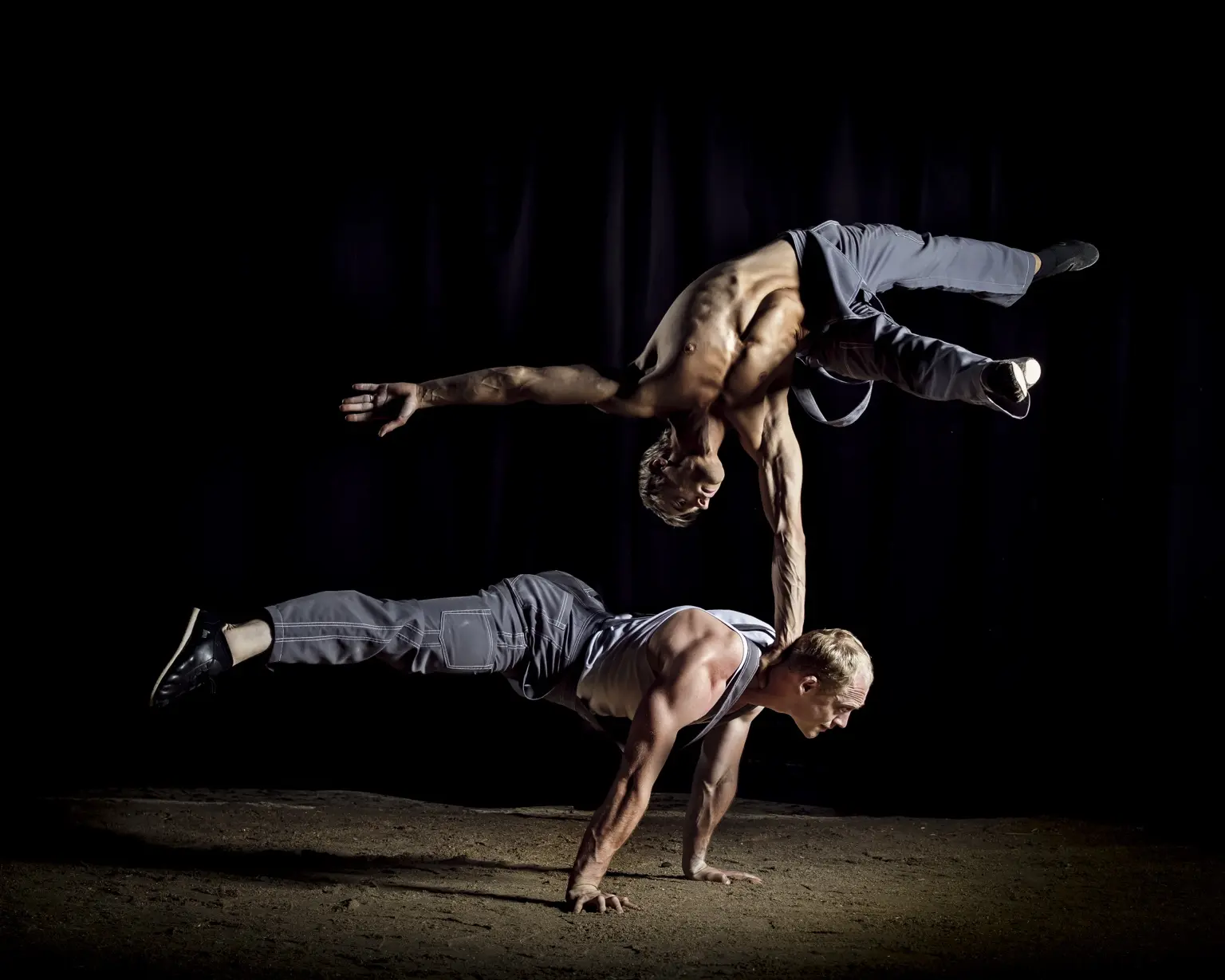 Dramatic partner balance against a black background