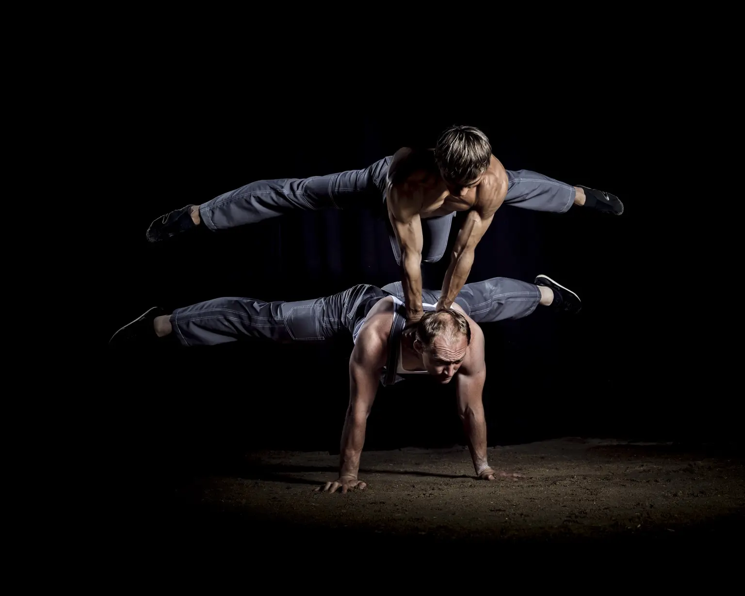 Layered partner balance against a black background