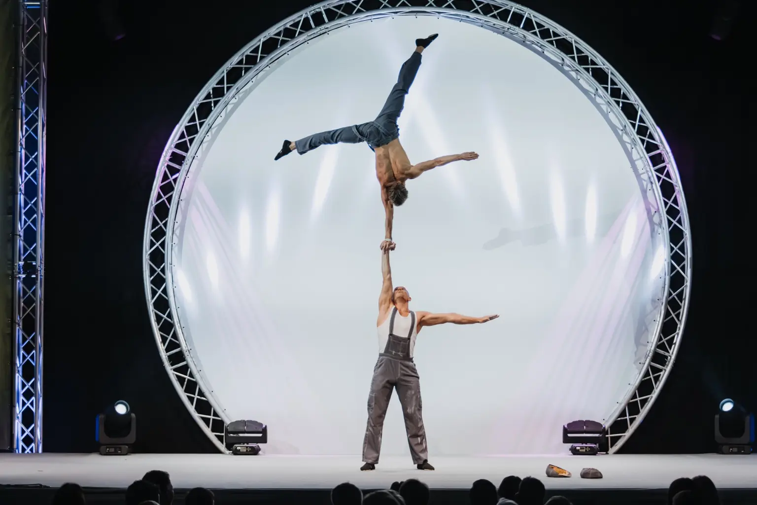 One-arm hand-to-hand balance on stage