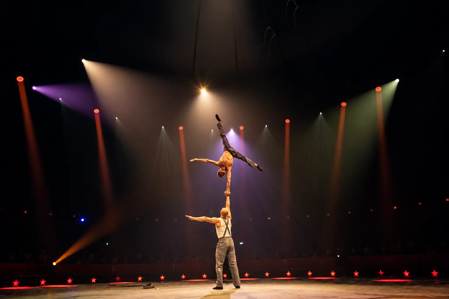 One-arm hand-to-hand balance in the circus ring