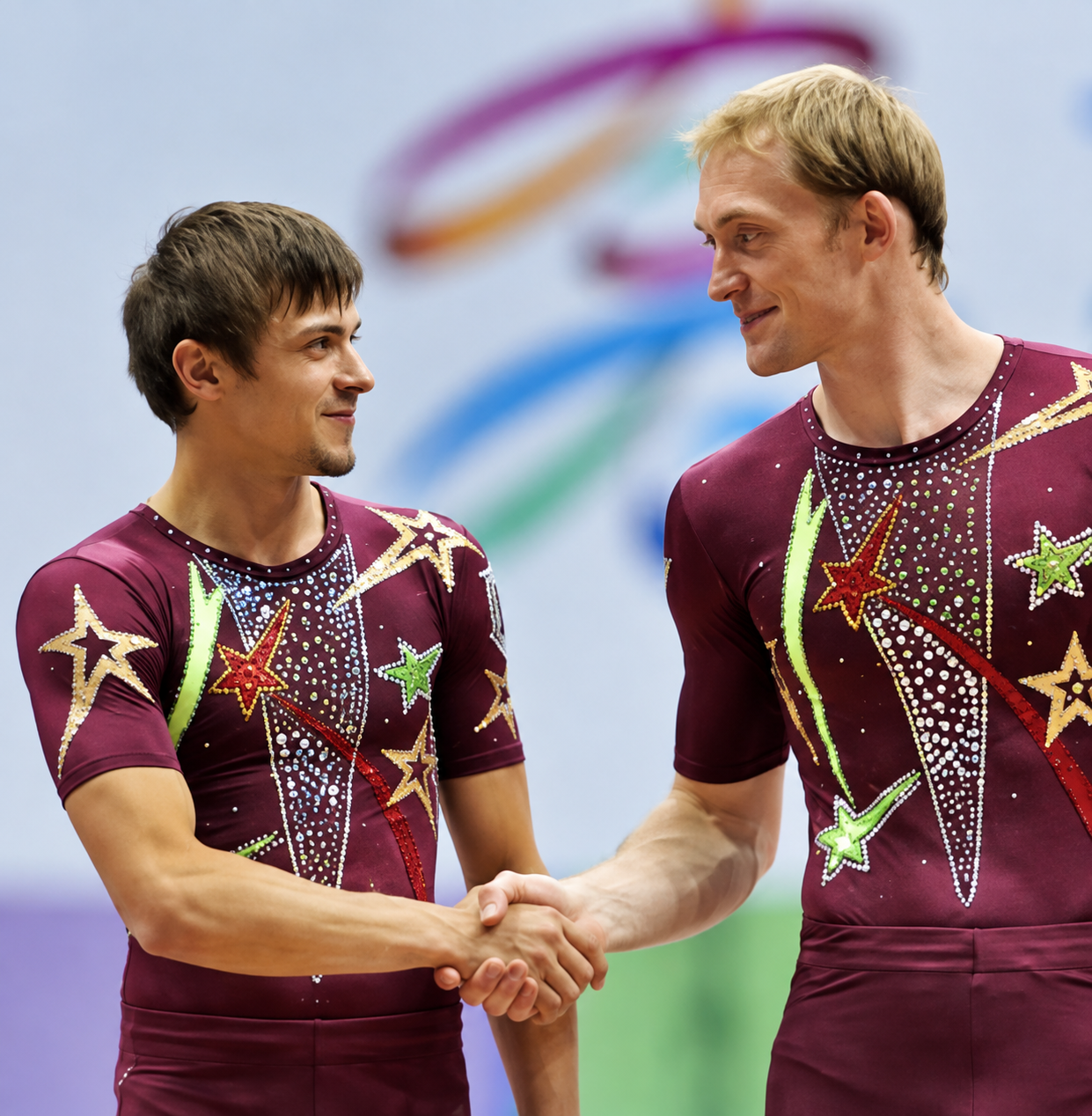 The acrobatic partners shaking hands after competition