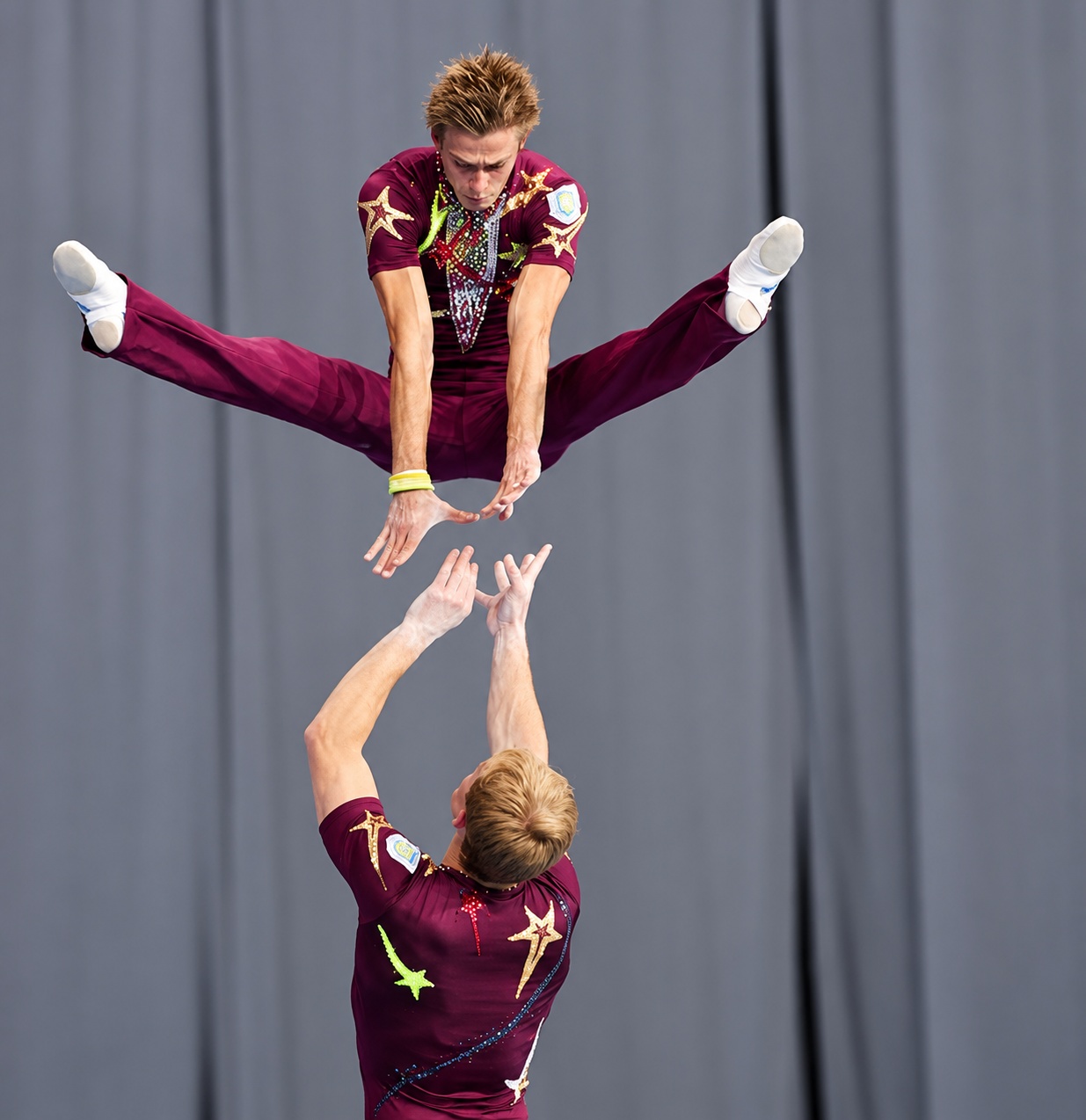 Dynamic flight element in maroon competition costumes